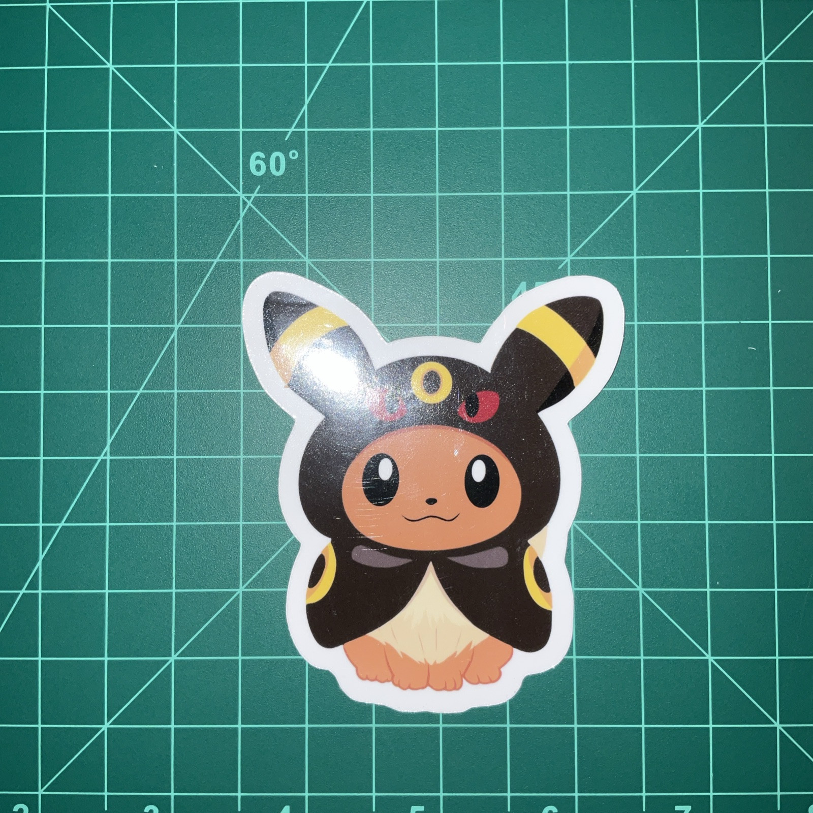 Pokemon Poncho wearing Eevee Uv Waterproof Sticker 3”x3”