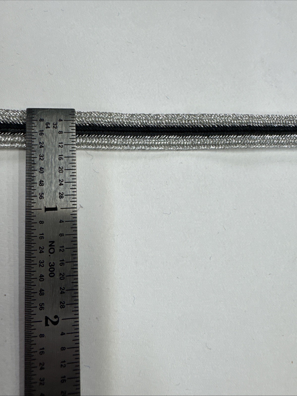 Rice Braid - 3/8” Metallic Silver With Black Center Stripe Braid. 110 Yards.