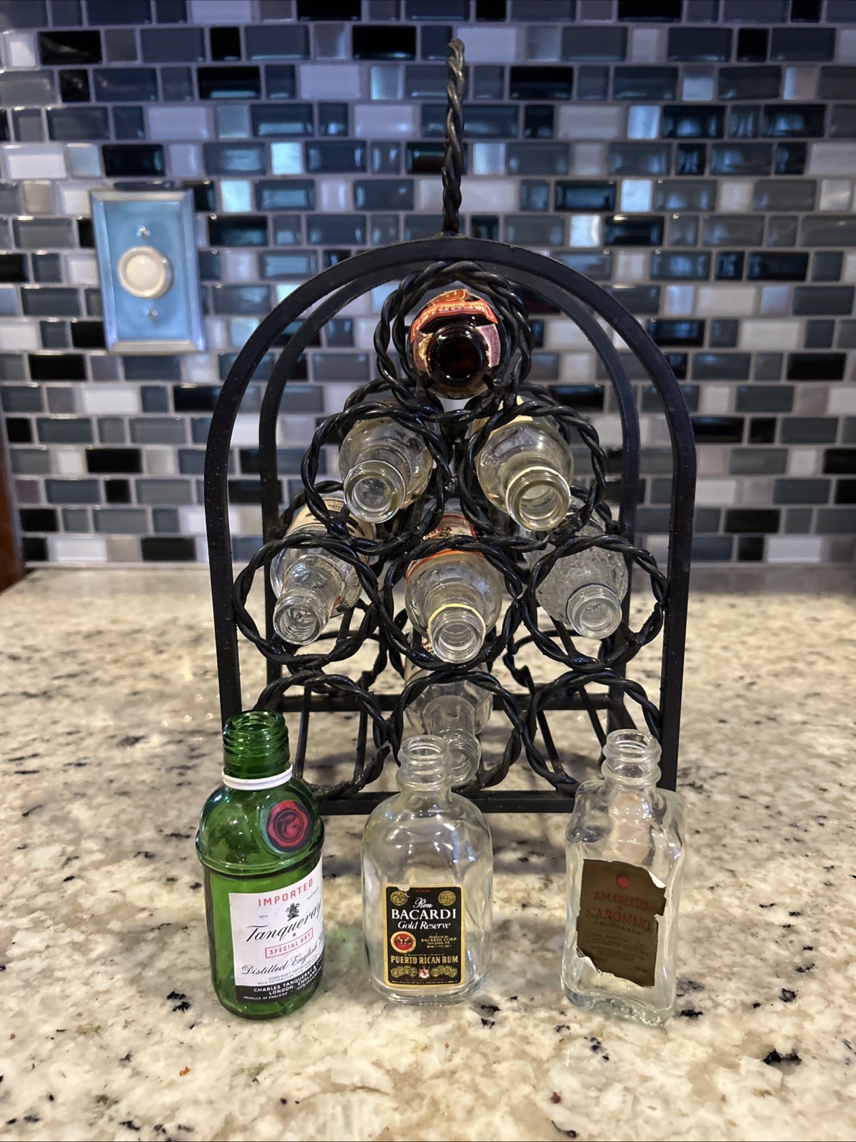 Lot of 10 Vintage Empty Mini Airplane Liquor Bottles plus cast iron storage rack