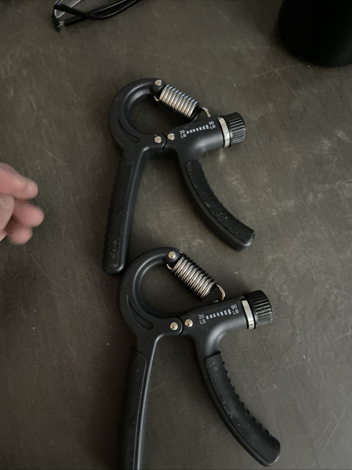 Two Handheld grip strength trainers - black - grey