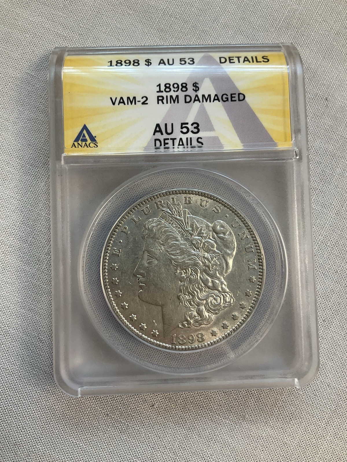 1898 Morgan Silver Dollar certified by ANACS AU 53 - Rim Damaged