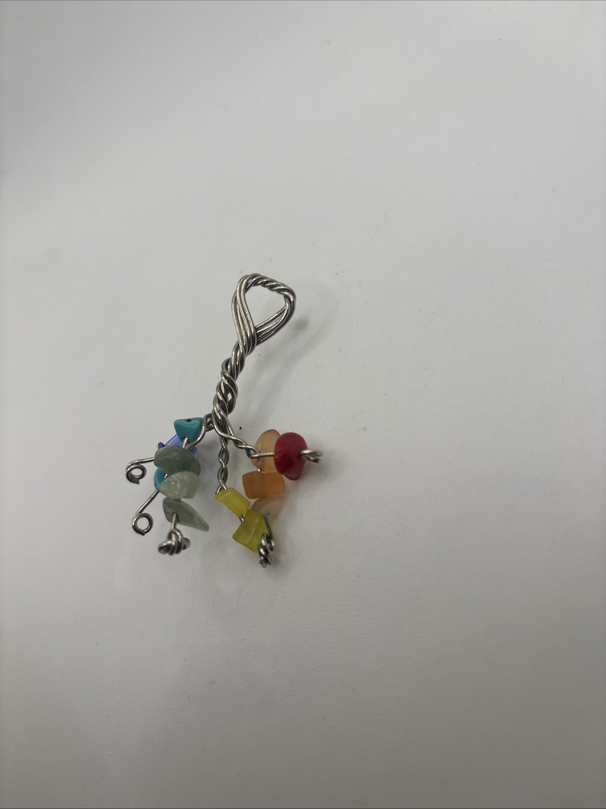 This is a handmade wire-wrapped keychain featuring multicolored gemstone chip