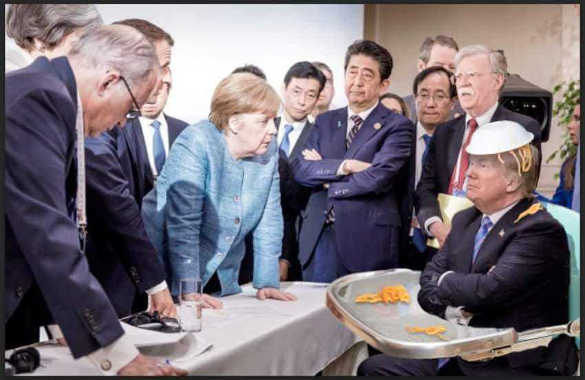 MERKEL STANDING OVER TRUMP IN HIGHCHAIR AT G7 HUMOUROUS FRIDGE MAGNET 5" X 3.5"