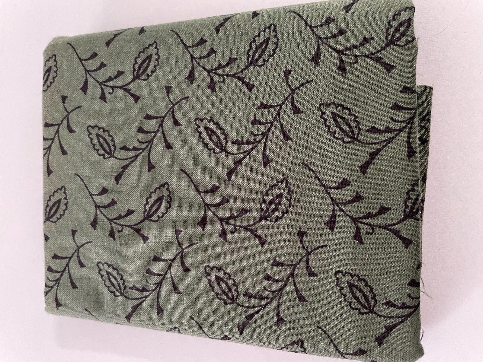 Quilting Fabric-Black design on dark green background