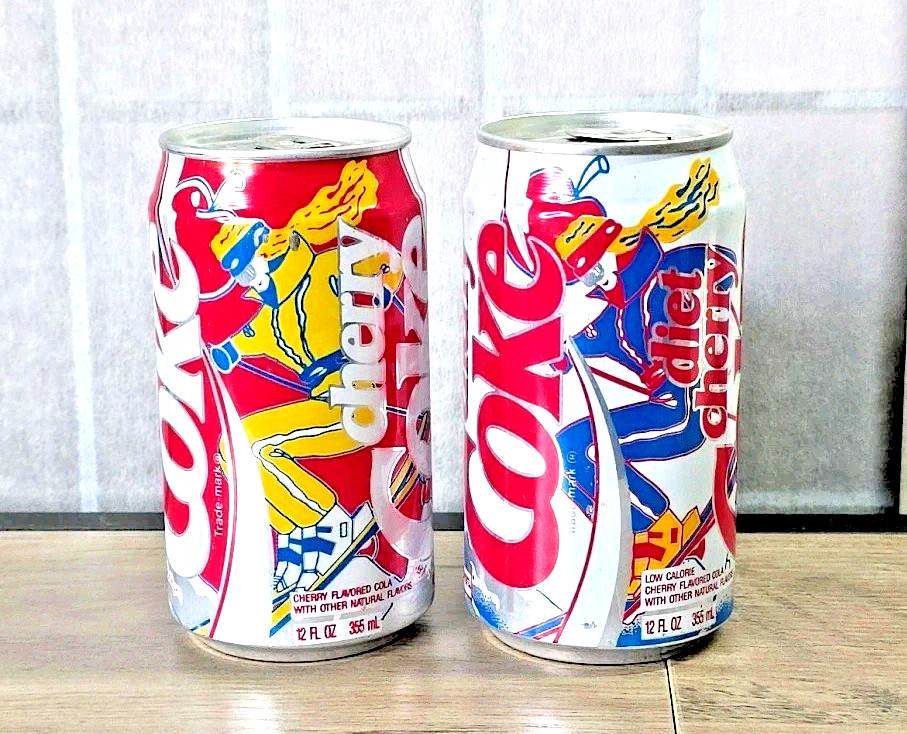 SKI UTAH Cans: 1 diet Cherry Coke, 1 Cherry Coca Cola, Blonde Girl Skiing, 1988