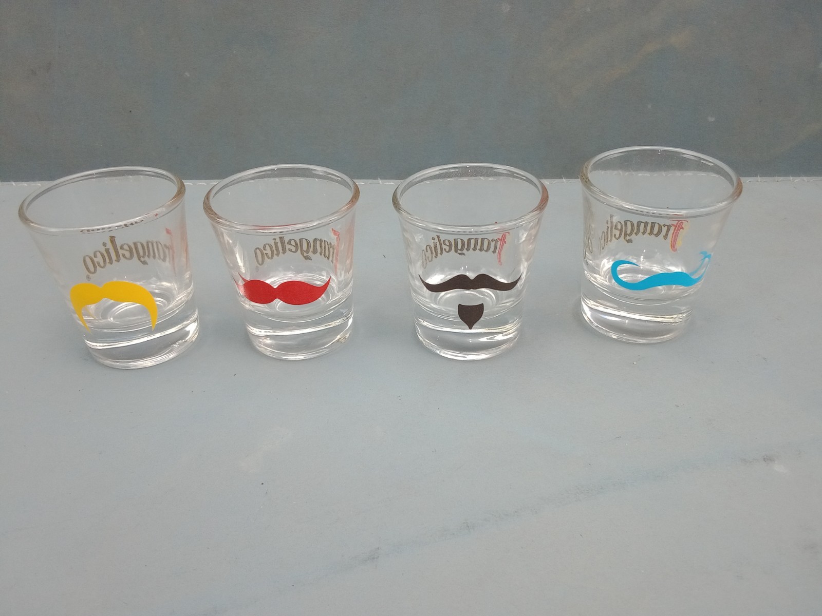 Frangelico Shot Glasses Set Of 4  Red Blue Yel Blk Mustaches Unique Barware