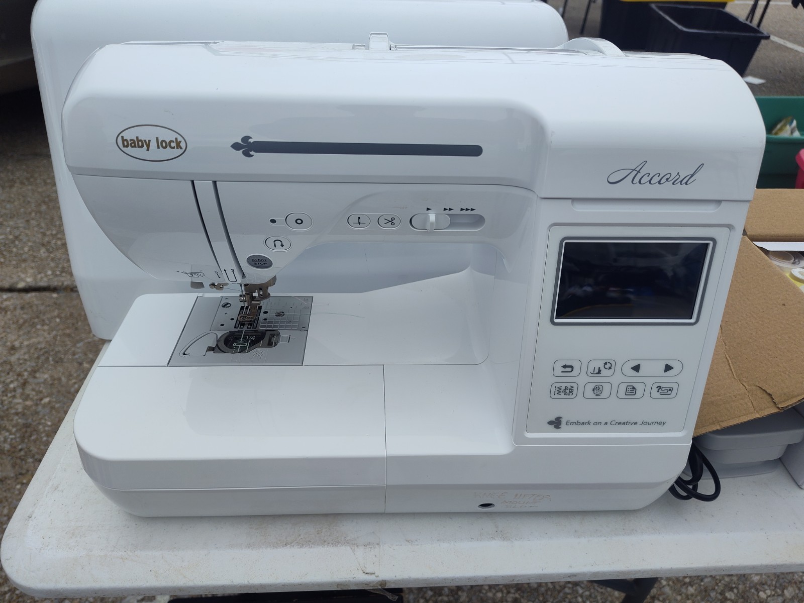 BabyLock Accord sewing and embroidery machine with accessories.
