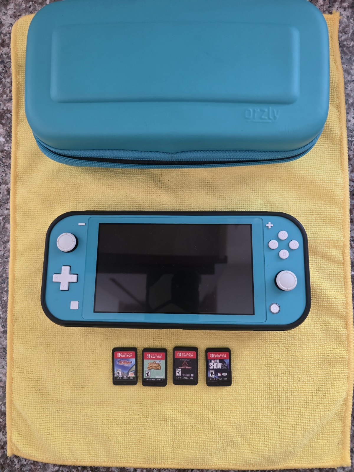 Nintendo Switch Lite- Turquoise -w/ Case And 4 Games. Good Condition! No Charger
