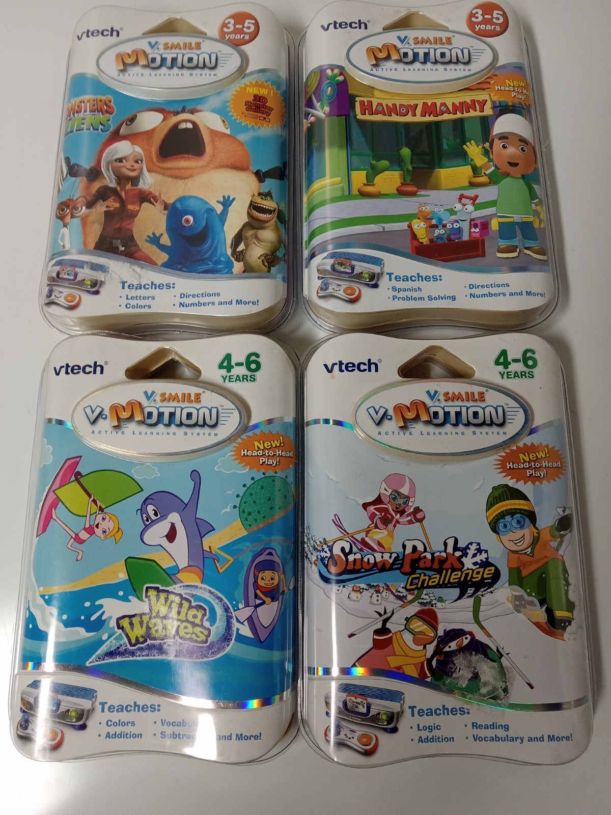Lot Of 4 VTech V.Smile Games Monster Alien,  Handy Manny, Wild Waves,Snow Park