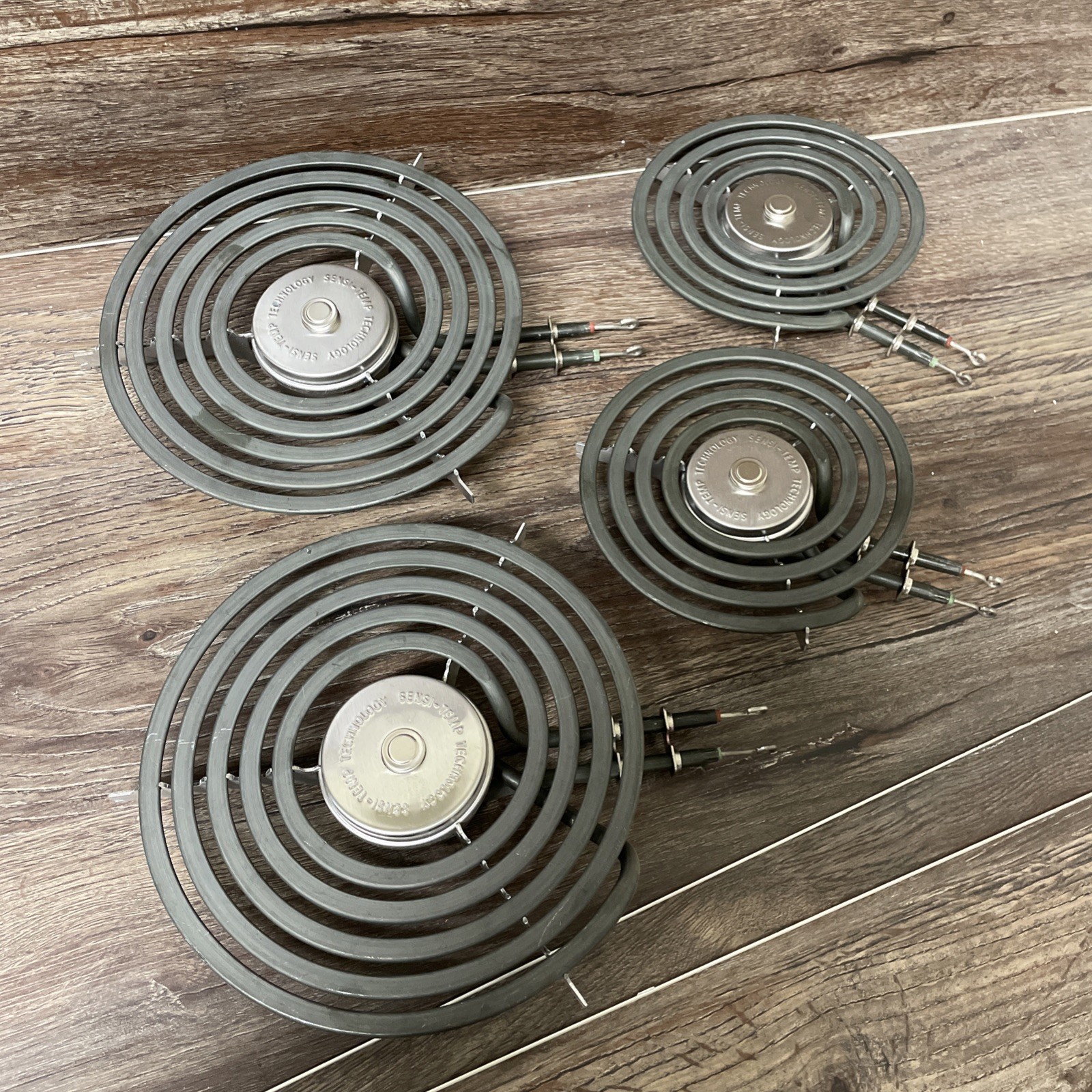 GE Stove-Top Burners Sensi-Temp Set. 2 are WB3OX31057 8" & 2 are WB30X31058 6"