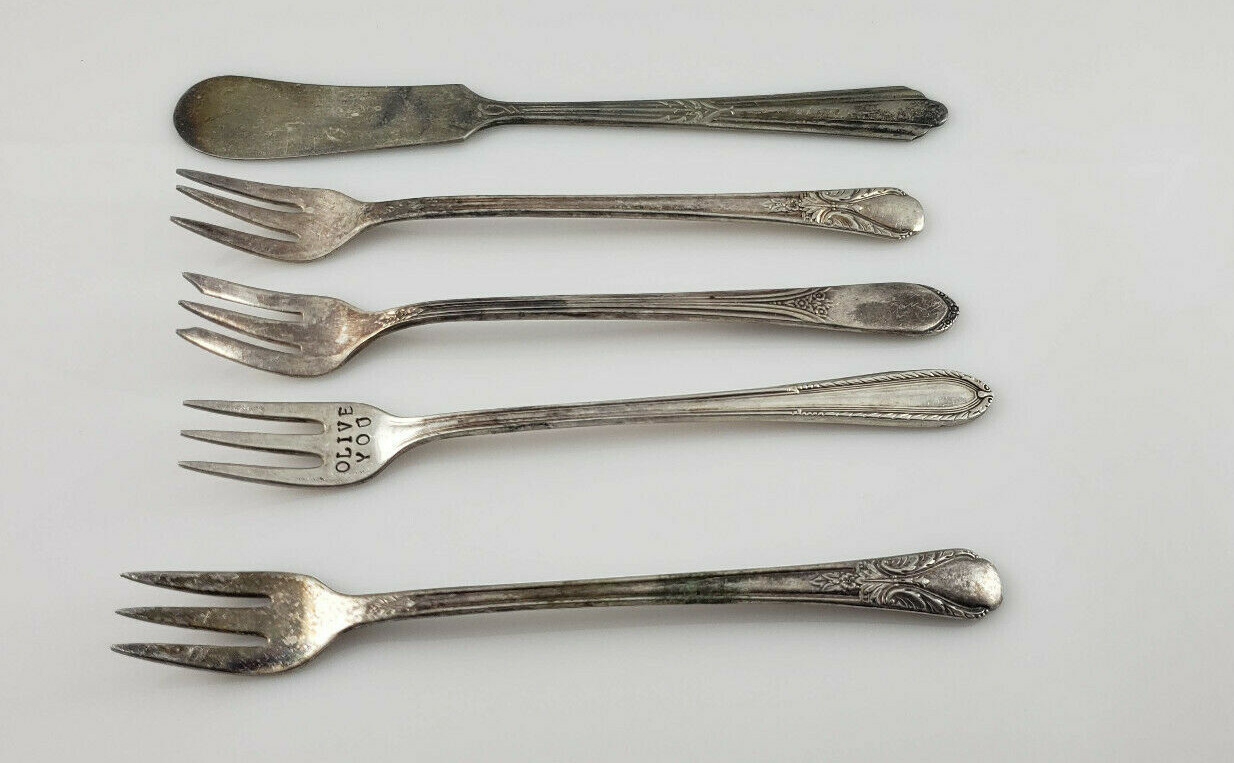 4 WM Rogers Cocktail forks and 1 Caroline Butter Knife