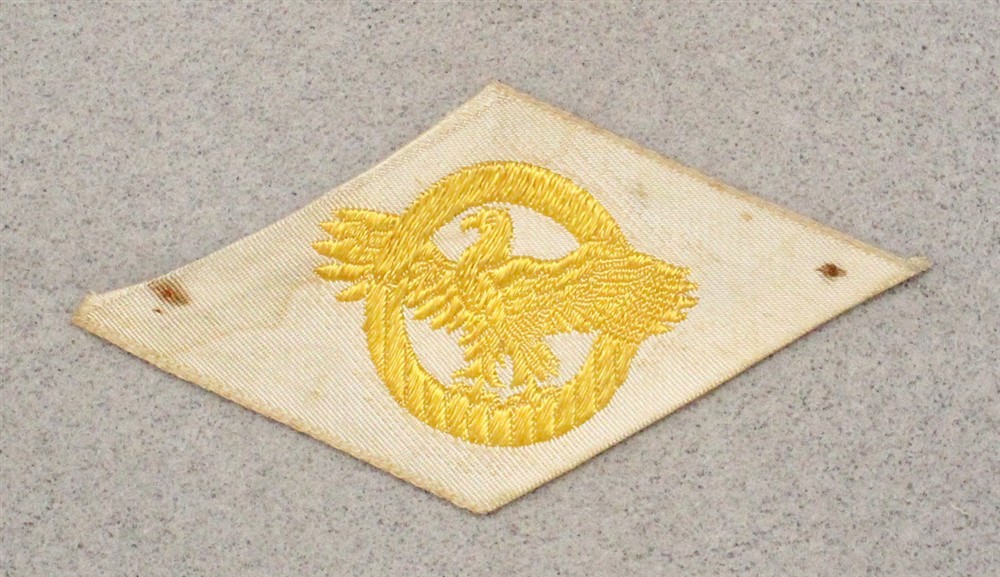 Cloth Military Badge 055: WWII Discharge Diamond, Ruptured Duck - woven on white