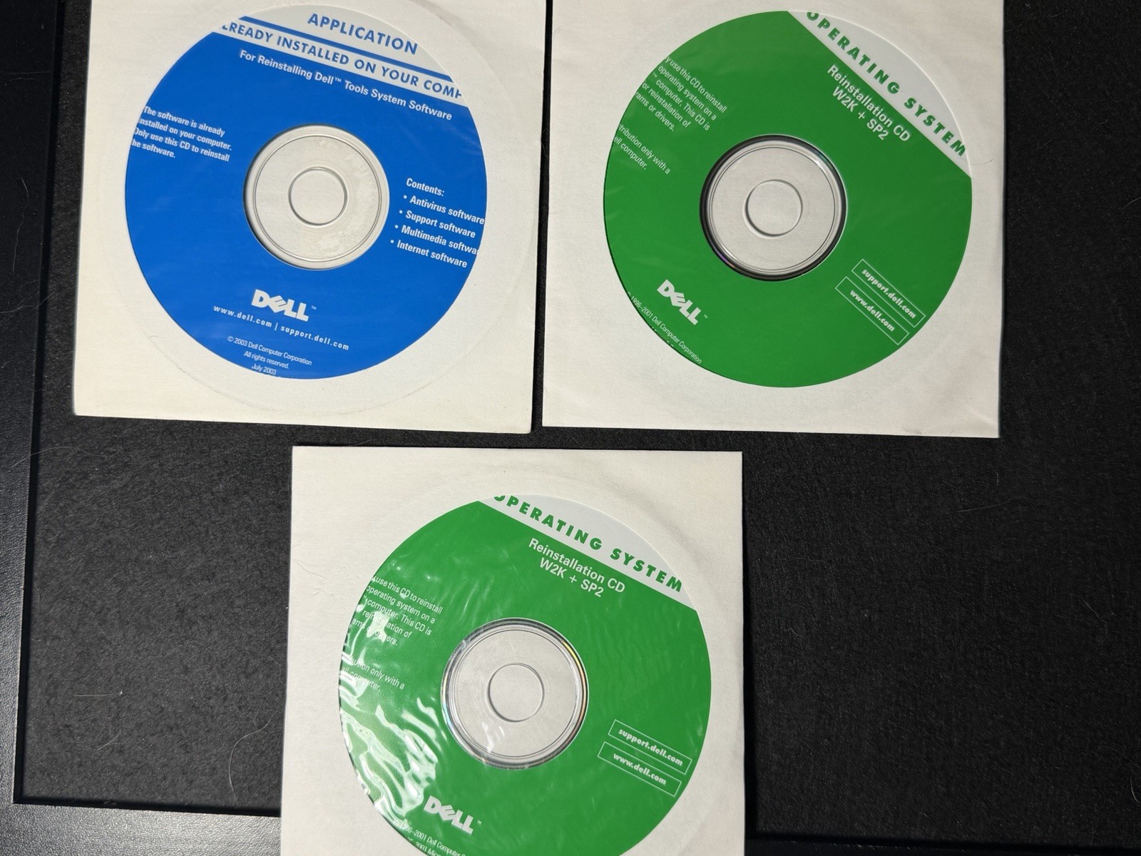 three vintage Dell reinstall CDs