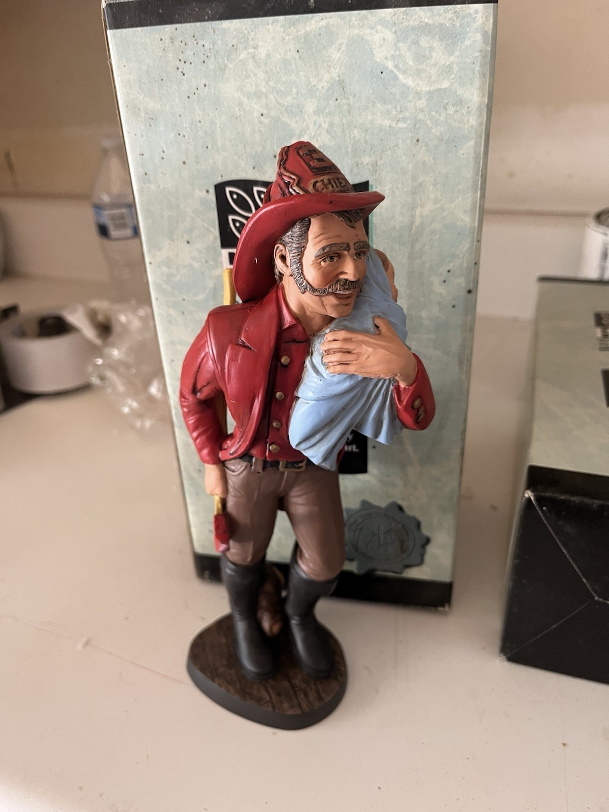 Fireman saving baby figurine from Benton Studios