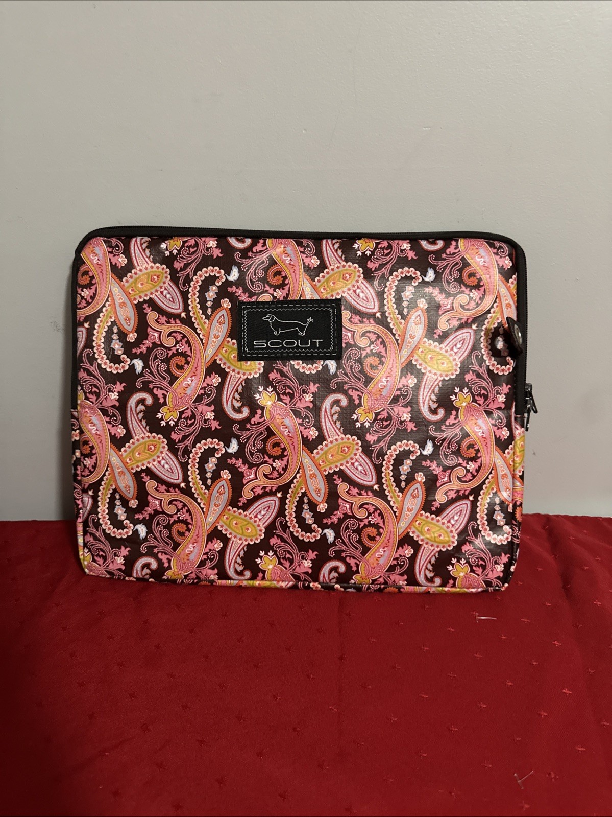 SCOUT brand laptop sleeve featuring a pink and brown paisley pattern