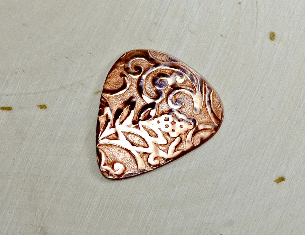 Rococo copper guitar pick with vines