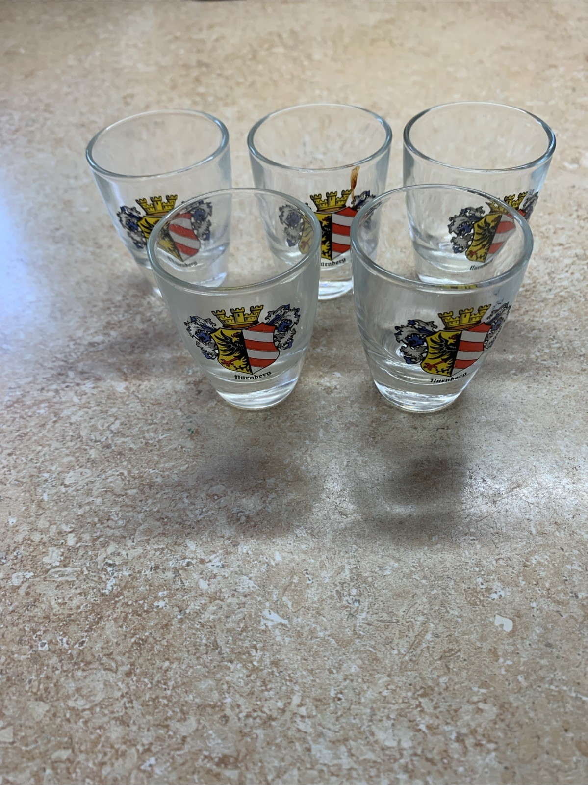 A Set of Five Shot Glasses Each Featuring A Coat of Arms with Nürnberg Germany
