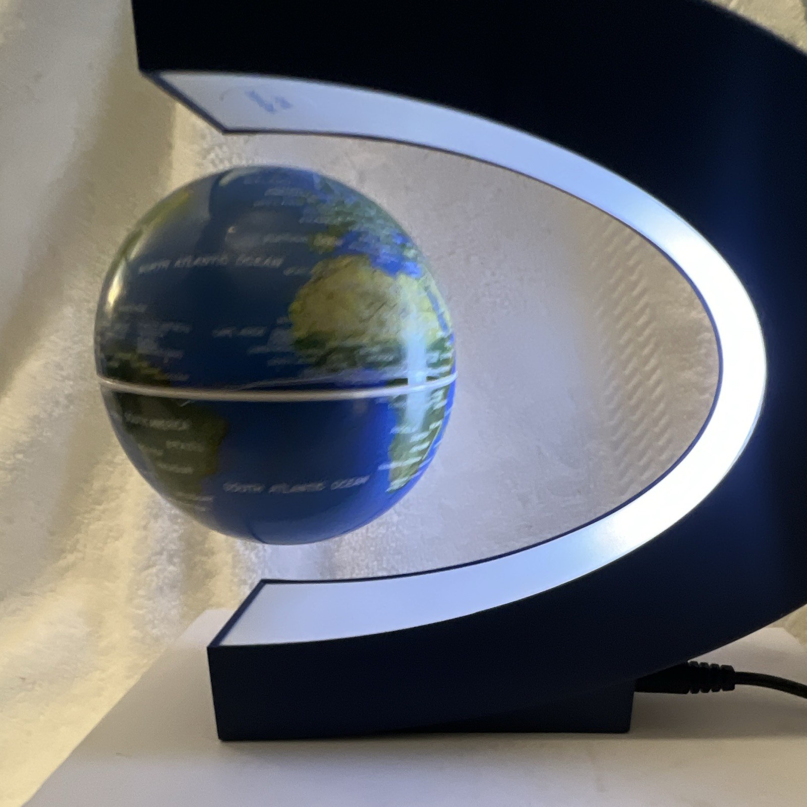 Modern Floating Tabletop Globe, Blue/Green Rotating Design, Black Base, Corded