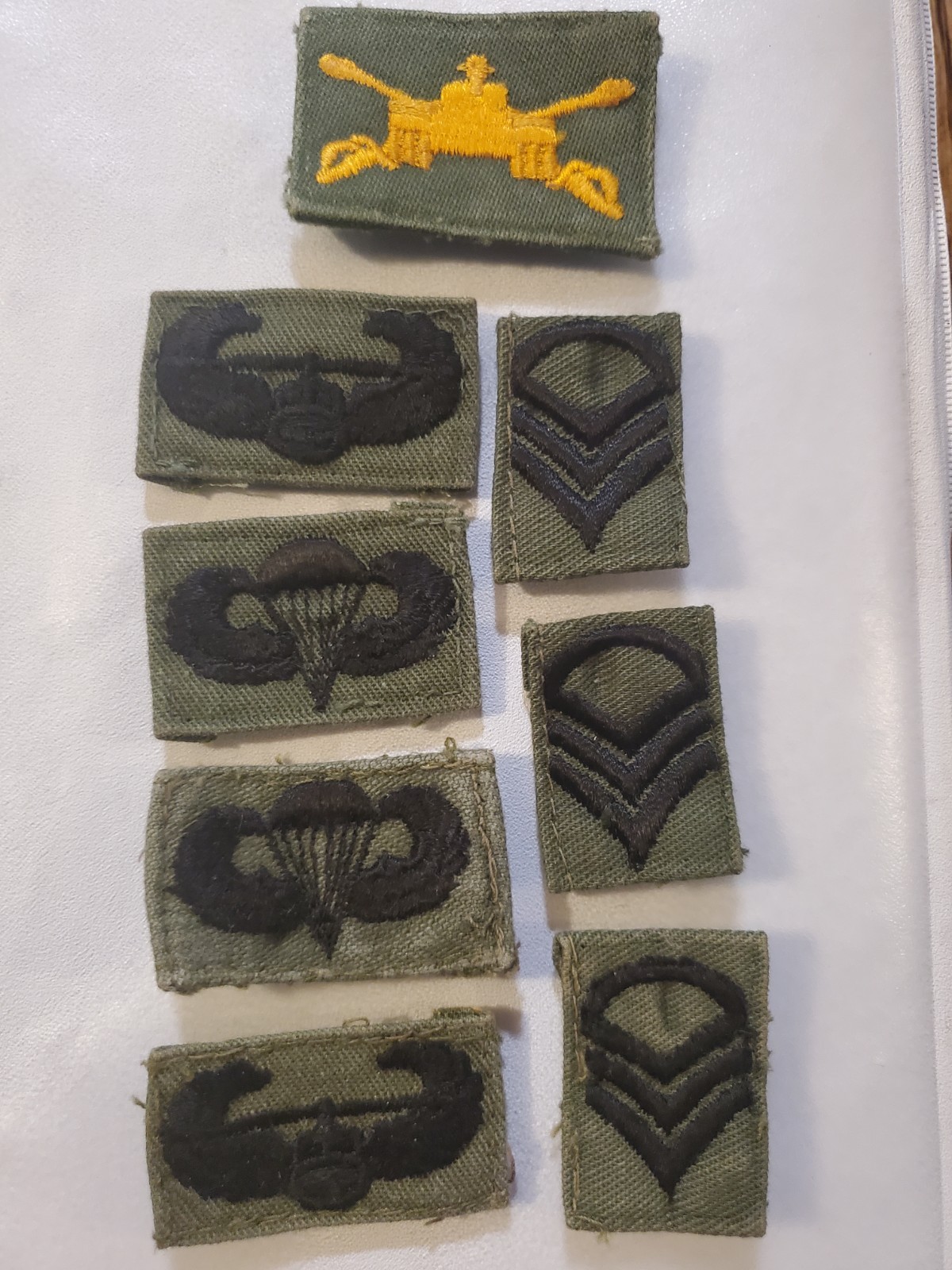 Vintage collection of subdued military patches, including United States Army...